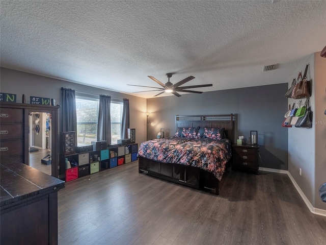 bedroom featuring dark hardwood / wood-style floors, a textured ceiling, and ceiling fan