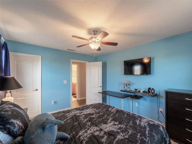 bedroom featuring a textured ceiling and ceiling fan