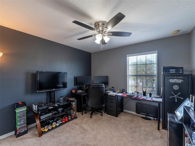 carpeted office space with ceiling fan and a textured ceiling