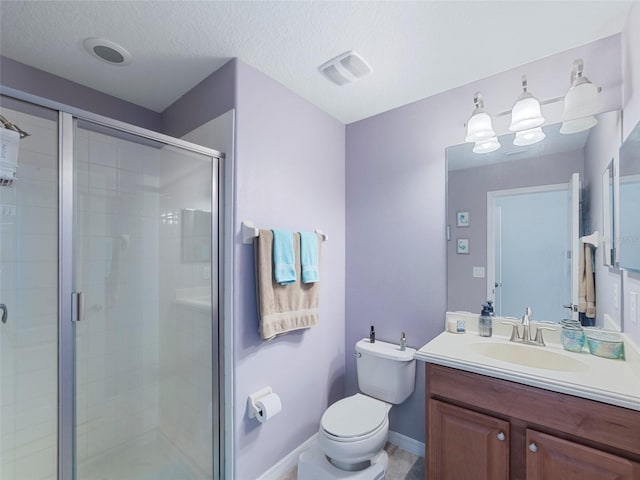 bathroom with vanity, a textured ceiling, a shower with door, and toilet