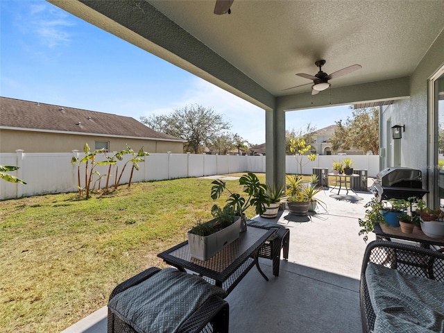 view of patio featuring area for grilling and ceiling fan