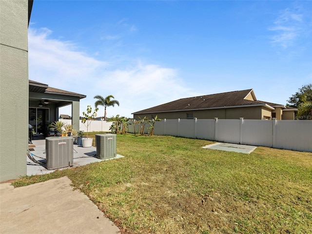 view of yard with central AC, a patio, and ceiling fan