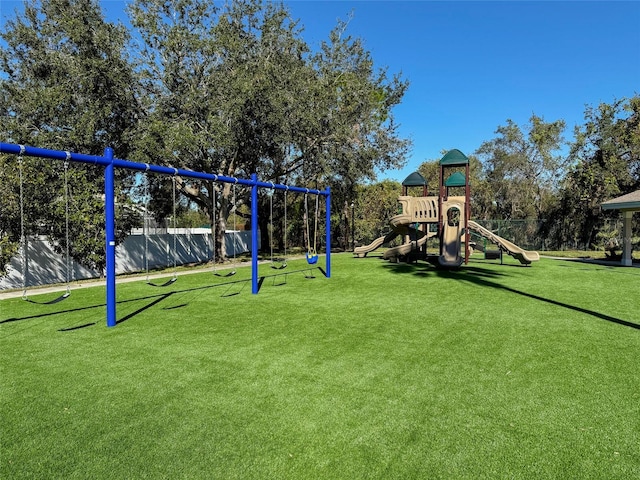 view of playground with a lawn