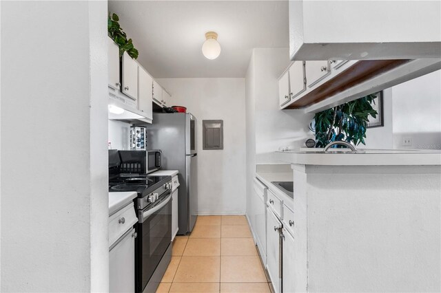 1400 Gandy Blvd N Unit 506, Saint Petersburg, FL 33702 - kitchen with light tile patterned floors, stainless steel appliances, and white cabinets