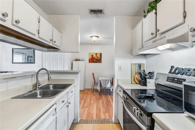 1400 Gandy Blvd N Unit 506, Saint Petersburg, FL 33702 - kitchen with light tile patterned flooring, dishwasher, sink, white cabinets, and electric stove