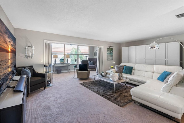 living room featuring a textured ceiling, carpet, and visible vents