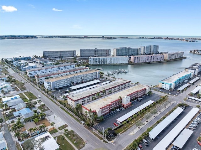 birds eye view of property with a water view and a view of city