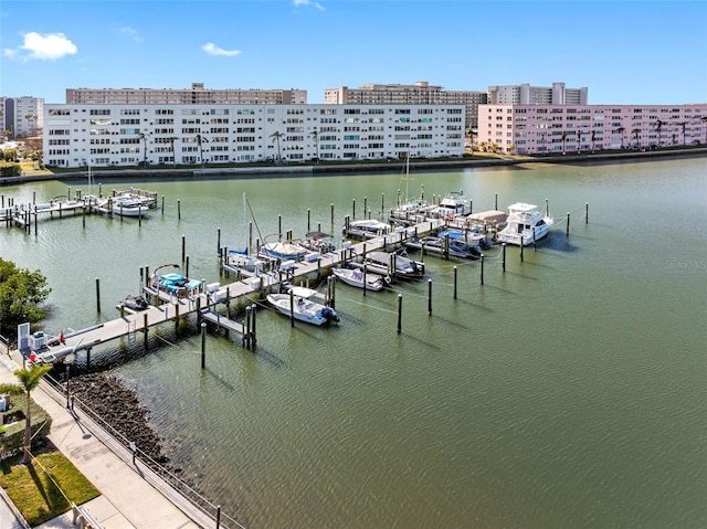 view of dock featuring a view of city, a water view, and boat lift