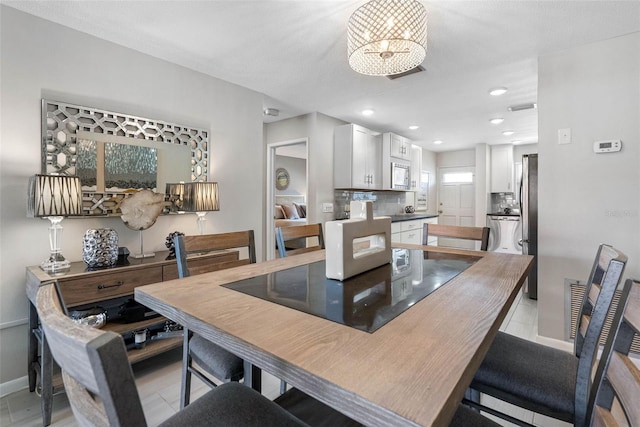 dining area featuring recessed lighting, baseboards, and light tile patterned floors