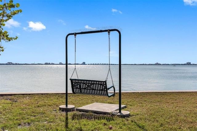 dock area featuring a water view and a lawn