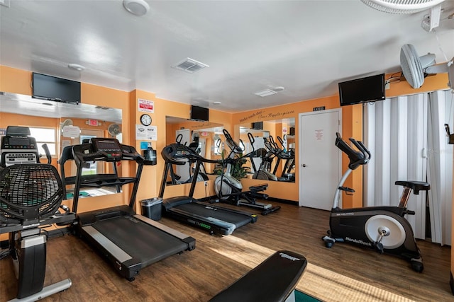 exercise room with visible vents and wood finished floors