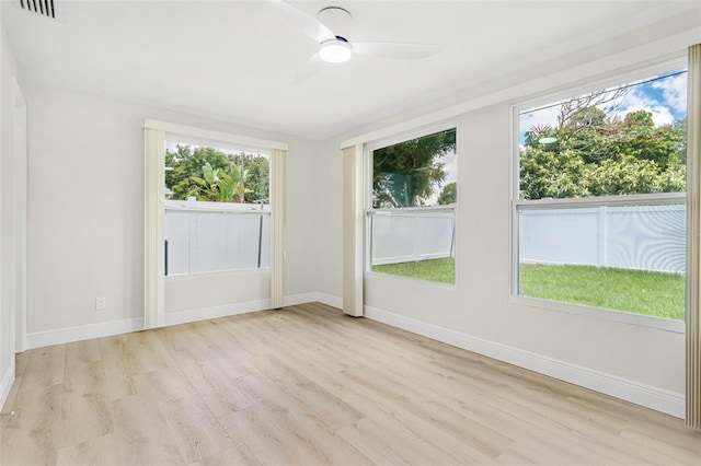 unfurnished room with ceiling fan, a healthy amount of sunlight, and light hardwood / wood-style floors