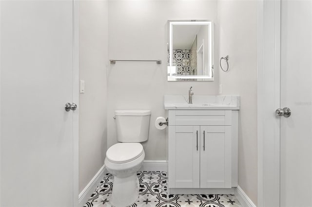 bathroom featuring tile patterned floors, vanity, and toilet