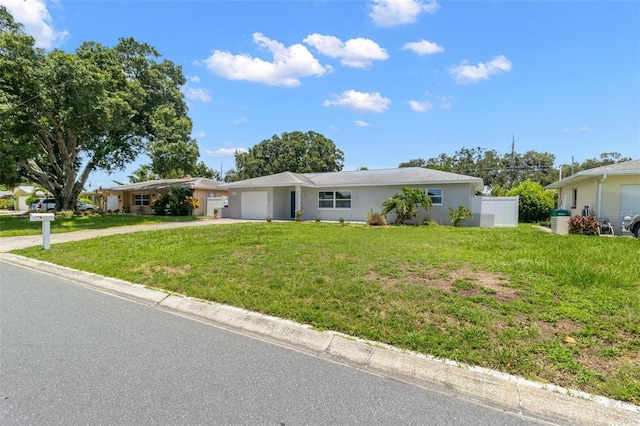 ranch-style house with a garage and a front yard