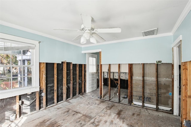 spare room featuring ornamental molding, visible vents, and a ceiling fan