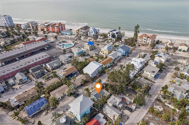 drone / aerial view featuring a beach view and a water view