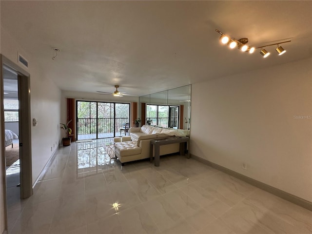 living room featuring ceiling fan and light tile patterned floors