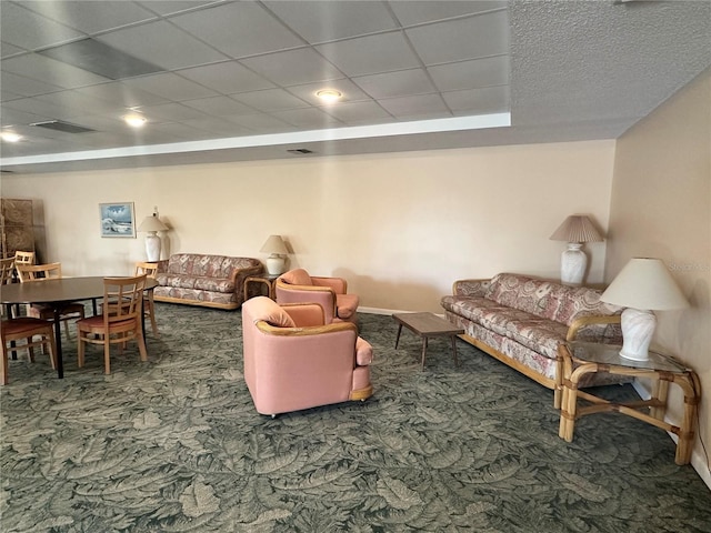 5400 Park St N Unit 209, Saint Petersburg, FL 33709 - carpeted living area featuring a paneled ceiling and baseboards