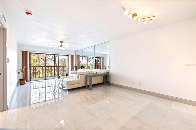 5400 Park St N Unit 209, Saint Petersburg, FL 33709 - living room with light marble finish floors, ceiling fan, and baseboards