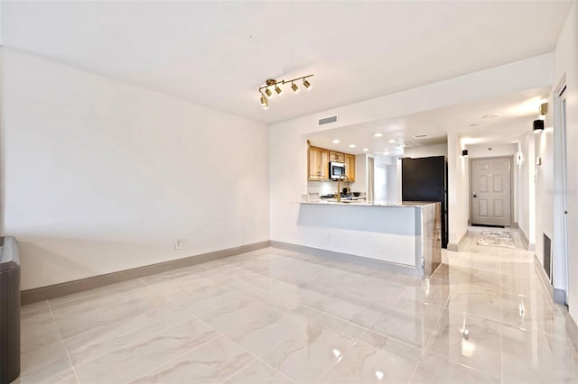 5400 Park St N Unit 209, Saint Petersburg, FL 33709 - unfurnished living room with light marble finish floors, baseboards, and recessed lighting