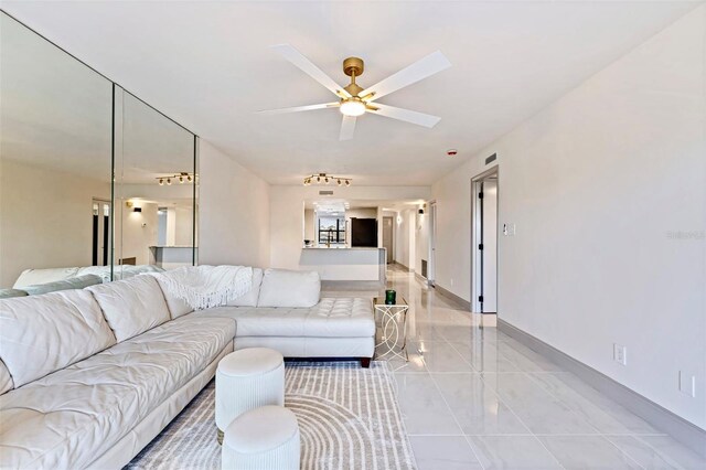 5400 Park St N Unit 209, Saint Petersburg, FL 33709 - living room with a ceiling fan, light tile patterned flooring, and baseboards