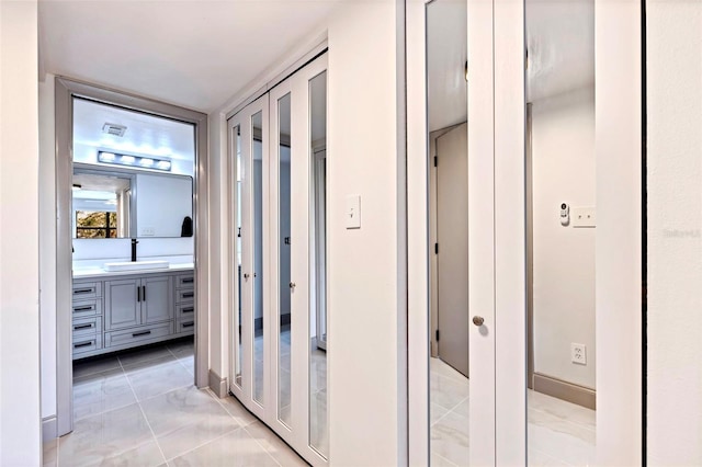 5400 Park St N Unit 209, Saint Petersburg, FL 33709 - hall with a sink and light marble finish flooring