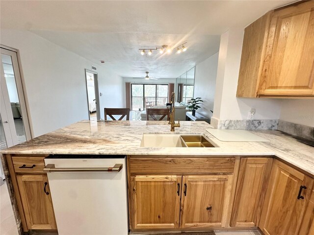 5400 Park St N Unit 209, Saint Petersburg, FL 33709 - kitchen featuring dishwasher, a sink, light stone counters, a peninsula, and open floor plan