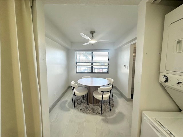 5400 Park St N Unit 209, Saint Petersburg, FL 33709 - dining room with stacked washer / drying machine, a ceiling fan, and baseboards