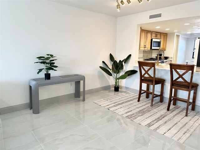 5400 Park St N Unit 209, Saint Petersburg, FL 33709 - dining space featuring light marble finish floors, baseboards, and recessed lighting