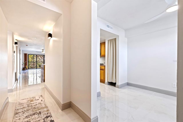5400 Park St N Unit 209, Saint Petersburg, FL 33709 - hallway with baseboards and light marble finish floors