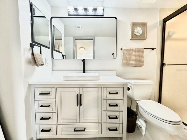 5400 Park St N Unit 209, Saint Petersburg, FL 33709 - bathroom with vanity, toilet, and a shower with shower door