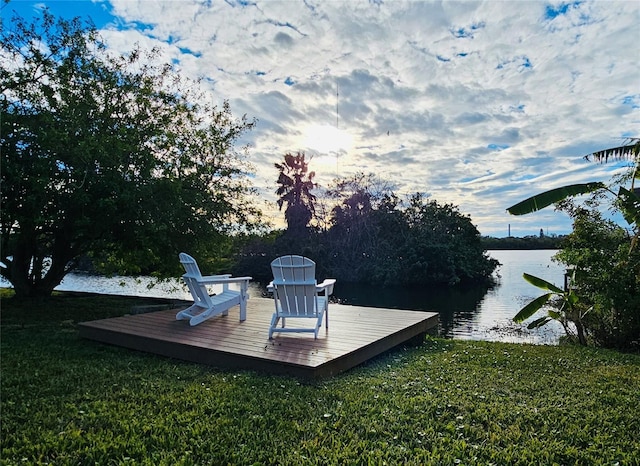 dock area with a water view and a yard