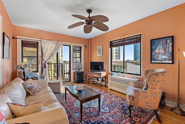 living room with hardwood / wood-style flooring, ceiling fan, and a healthy amount of sunlight