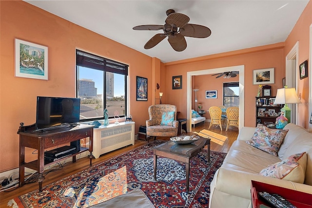 living room with hardwood / wood-style flooring and ceiling fan