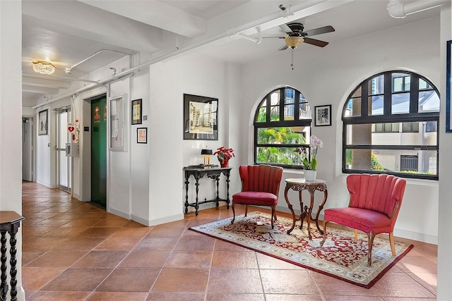 sitting room with elevator and ceiling fan