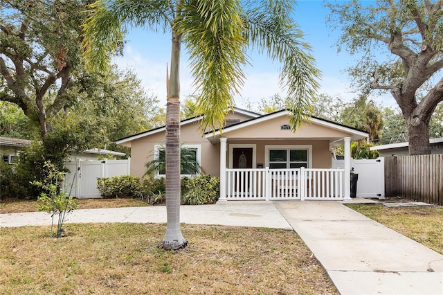 bungalow with a porch and a front yard