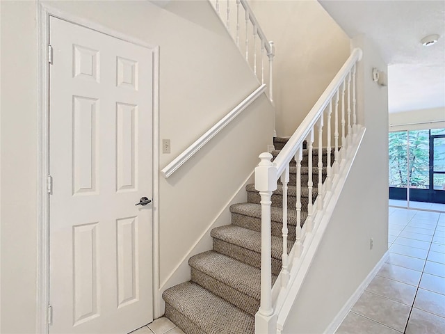 stairway featuring tile patterned floors