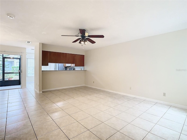 empty room with light tile patterned floors and ceiling fan