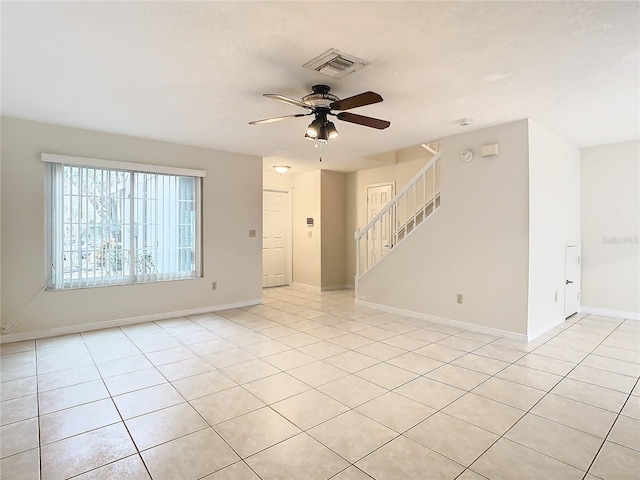 unfurnished room featuring light tile patterned floors and ceiling fan