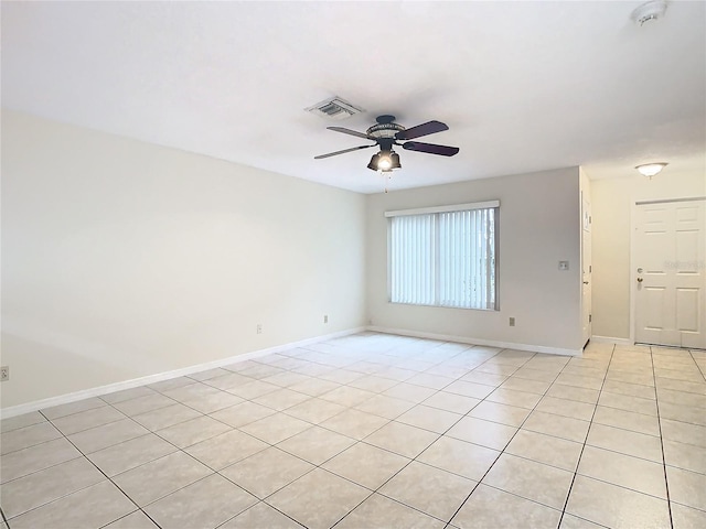 tiled spare room with ceiling fan