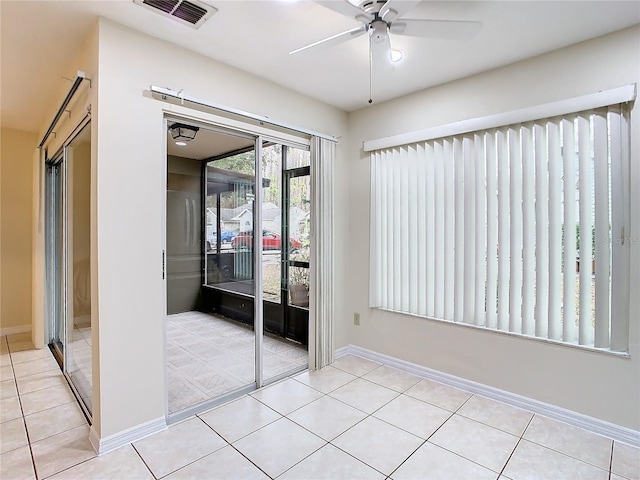 unfurnished bedroom featuring light tile patterned flooring, ceiling fan, and a closet