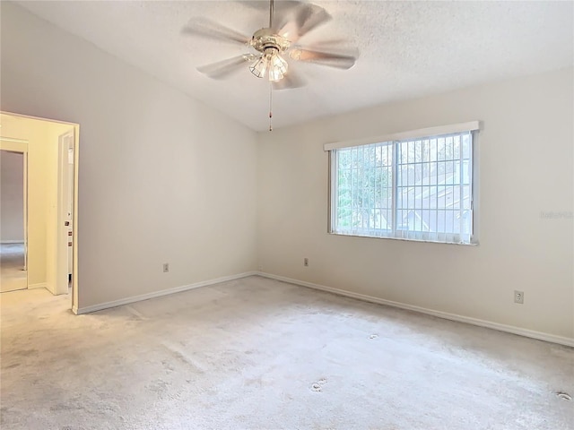 carpeted empty room with a textured ceiling and ceiling fan