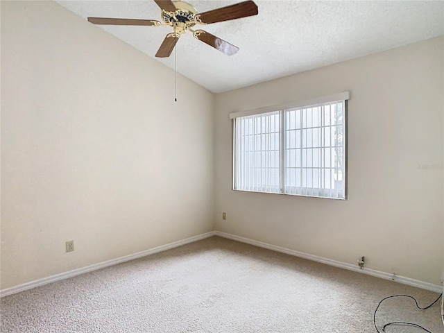 unfurnished room featuring ceiling fan, lofted ceiling, carpet flooring, and a textured ceiling