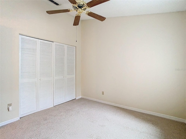 unfurnished bedroom featuring carpet floors, a closet, and ceiling fan