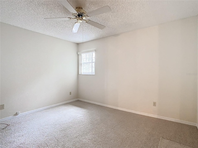 carpeted spare room with ceiling fan and a textured ceiling