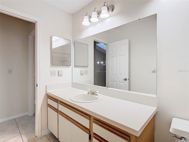 bathroom featuring vanity, tile patterned floors, and toilet