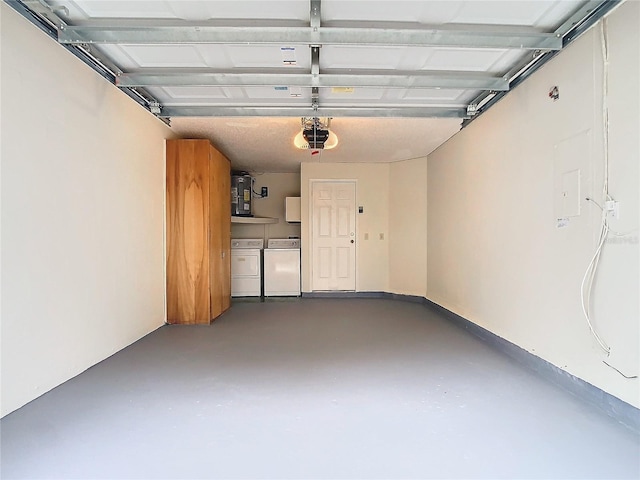 garage featuring independent washer and dryer and a garage door opener