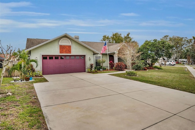 ranch-style home featuring a garage and a front yard