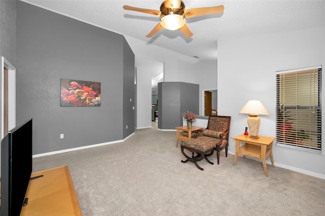 sitting room featuring vaulted ceiling, light colored carpet, a textured ceiling, and ceiling fan