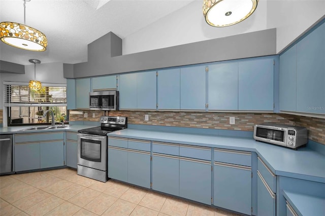 kitchen featuring appliances with stainless steel finishes, sink, and blue cabinetry